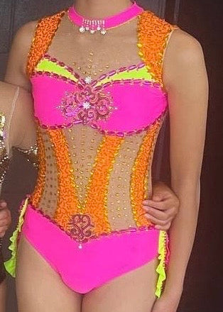 Colourful calisthenics costume with a pink and orange accents.